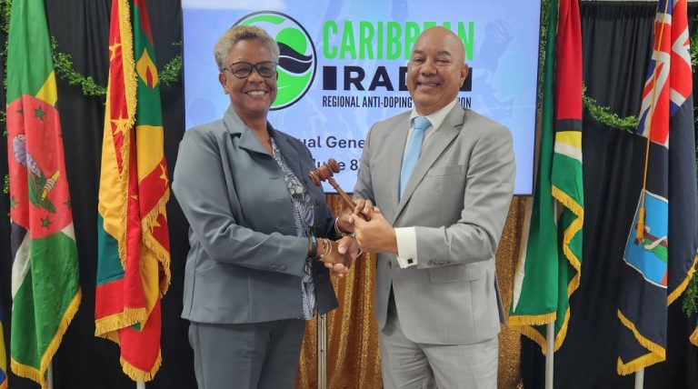 Photo 1 Outgoing Chair Patrick Werleman passing the gavel to New Chair Dr. Karen Pilgrim (Guyana)